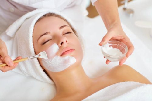 Woman in mask on face in spa beauty salon. Woman in mask on face in spa beauty salon.
